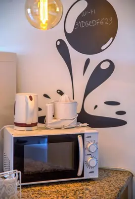 a microwave with some dishes on top of it at ALFELI-AP in Olhos de Água