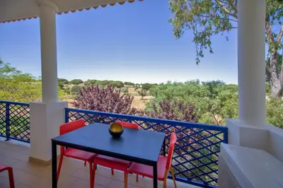 a table and chairs on a balcony with a view at ALFELI-AP in Olhos de Água