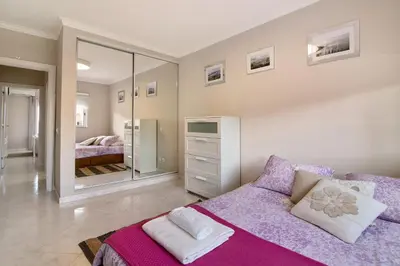 a bedroom with a purple bed and a mirror at Vilamoura Apartment 3 bedroom in Vilamoura