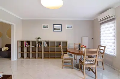 a living room with a table and a book shelf at Vilamoura Apartment 3 bedroom in Vilamoura