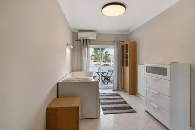a kitchen with a refrigerator and a table in it at Vilamoura Apartment 3 bedroom in Vilamoura