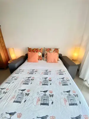 a bedroom with a bed with a blanket on it at Sweet Garden by SpotOn Apartments in Albufeira