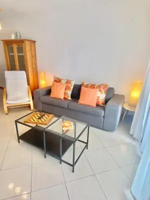 a living room with a couch and a table at Sweet Garden by SpotOn Apartments in Albufeira
