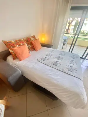 a bed with pillows on it in a room at Sweet Garden by SpotOn Apartments in Albufeira