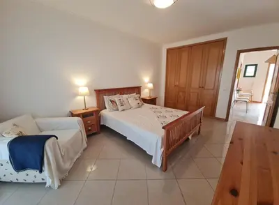 a bedroom with two beds and a table with two lamps at Sweet Garden by SpotOn Apartments in Albufeira