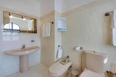 a bathroom with a toilet and a sink at Villa Albuar in Patroves
