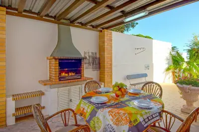 a table and chairs with a fireplace on a patio at Villa Albuar in Patroves