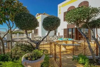 a patio with trees in front of a building at Villa Albuar in Patroves