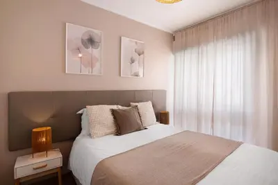 a bedroom with a large bed and a window at Casa Maria in Faro