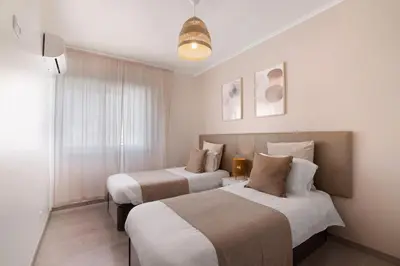 two beds sitting next to each other in a room at Casa Maria in Faro