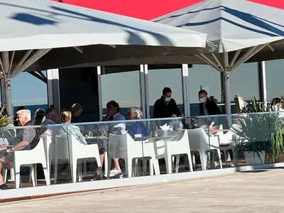 a group of people sitting at tables on a roof at Terraços Quarteira 2D3 in Quarteira