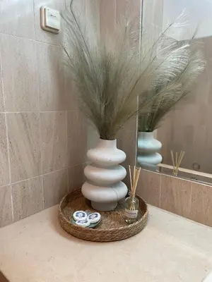 a white vase sitting on a counter in a bathroom at Title e Title - Oura Apartament Albufeira in Albufeira