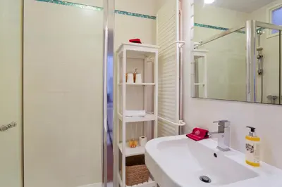 a white bathroom with a shower and a sink at Townhouse Seraphina in Vale do Lobo