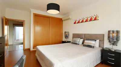 a bedroom with a bed with a white bedspread at Villa Terraços da Vinha 230 - Clever Details in Vilamoura
