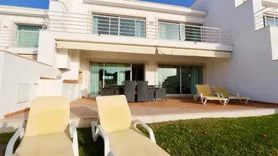 a house with two chairs and a patio at Villa Terraços da Vinha 230 - Clever Details in Vilamoura