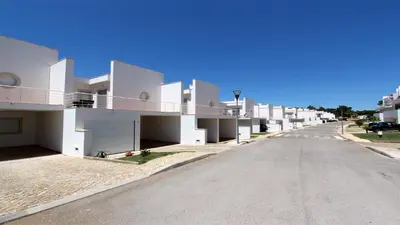 an empty street in front of a white building at Villa Terraços da Vinha 230 - Clever Details in Vilamoura