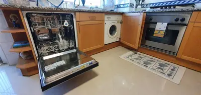 a kitchen with an oven and a dishwasher in it at Apartamento Dionisio in Albufeira
