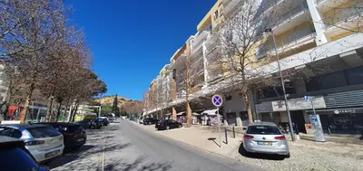 a street with cars parked on the side of a building at Apartamento Dionisio in Albufeira