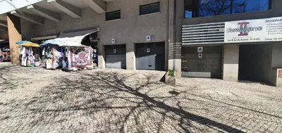 a shadow of a tree on the ground in front of a building at Apartamento Dionisio in Albufeira