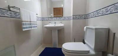 a bathroom with a toilet and a sink at Apartamento Dionisio in Albufeira