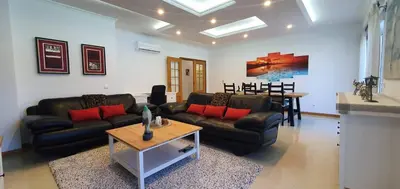 a living room with couches and a table and a dining room at Apartamento Dionisio in Albufeira