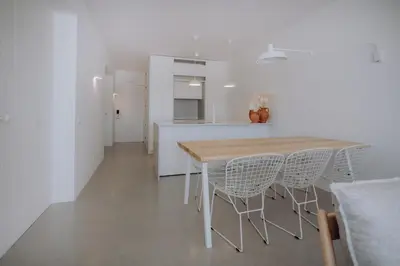 a kitchen and dining room with a table and chairs at Casa Balaia 70 in Albufeira