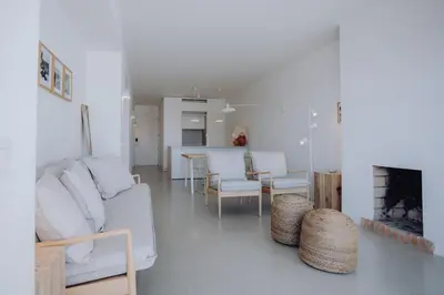 a living room with a couch and chairs and a fireplace at Casa Balaia 70 in Albufeira