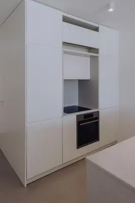 a kitchen with white cabinets and a stove at Casa Balaia 70 in Albufeira