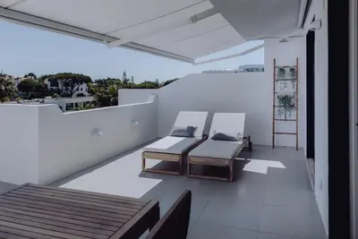 a balcony with two beds on a white wall at Casa Balaia 70 in Albufeira