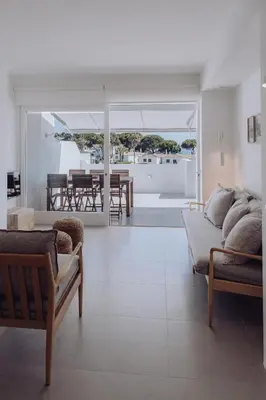 a living room with two couches and a dining room at Casa Balaia 70 in Albufeira