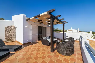 a patio with furniture on a roof at Villa Eva by OCvillas in Albufeira