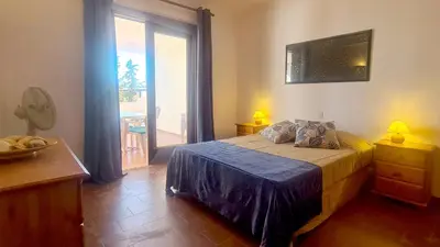 a bedroom with a bed and a large window at Albufeira Balaia Mar e Sol in Albufeira