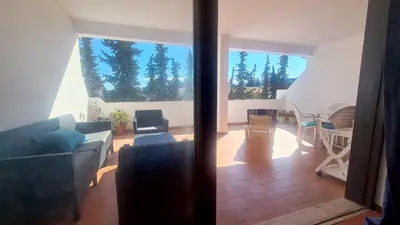 a living room with a couch and a table at Albufeira Balaia Mar e Sol in Albufeira