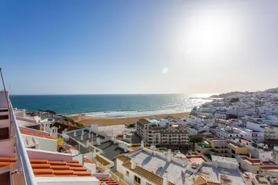 a view of a beach with buildings and the ocean at Old Town Beach Apartments in Albufeira