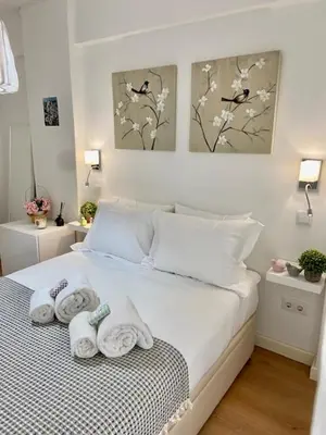 a bedroom with a bed with towels on it at Cosy Avenida Apartment in Faro