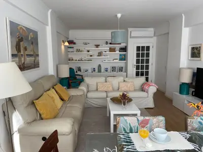 a living room with a couch and a table at Cosy Avenida Apartment in Faro