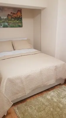 a bedroom with a white bed with a rug at Sun way in Albufeira