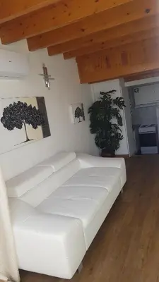 a white couch in a living room with a wooden ceiling at Sun way in Albufeira