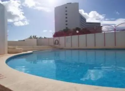 a large swimming pool in front of a building at Sun way in Albufeira
