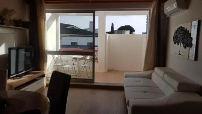 a living room with a couch and a large window at Sun way in Albufeira