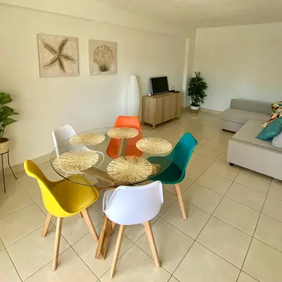 a table with a plate of cookies and a bottle of champagne at Vilamoura holidays house in Vilamoura
