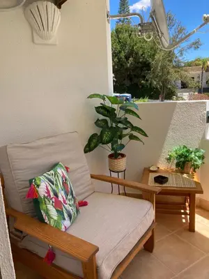 a table with a plate of food and a cup of orange juice at Vilamoura holidays house in Vilamoura