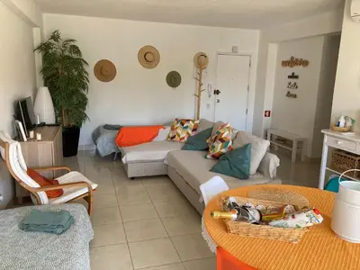 a living room with a glass table and chairs at Vilamoura holidays house in Vilamoura
