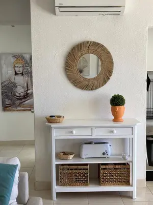 a white console table with a mirror in a living room at Vilamoura holidays house in Vilamoura