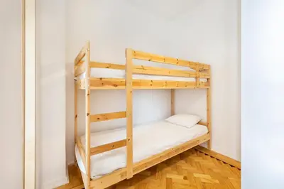 a bunk bed in a room with a ladder at RG Sunny Ap in Faro
