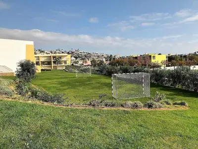 a yard with a goal in the grass at MARINA BLEU Magnifique Appartement Standing vue Piscine in Albufeira