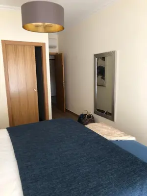 a bedroom with a large bed and a mirror at MARINA BLEU Magnifique Appartement Standing vue Piscine in Albufeira