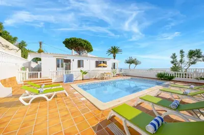 a swimming pool with green chairs and a patio at Villa Brigida in Patroves