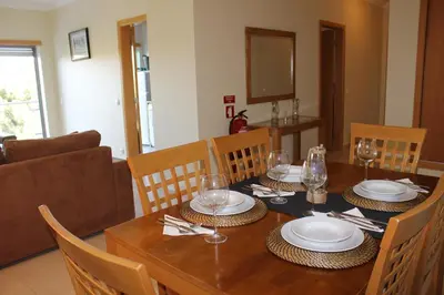 a dining room table with plates and glasses on it at Casa Jacqueline in Albufeira