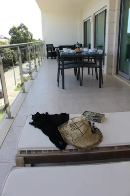 a hat sitting on a table on a balcony at Casa Jacqueline in Albufeira